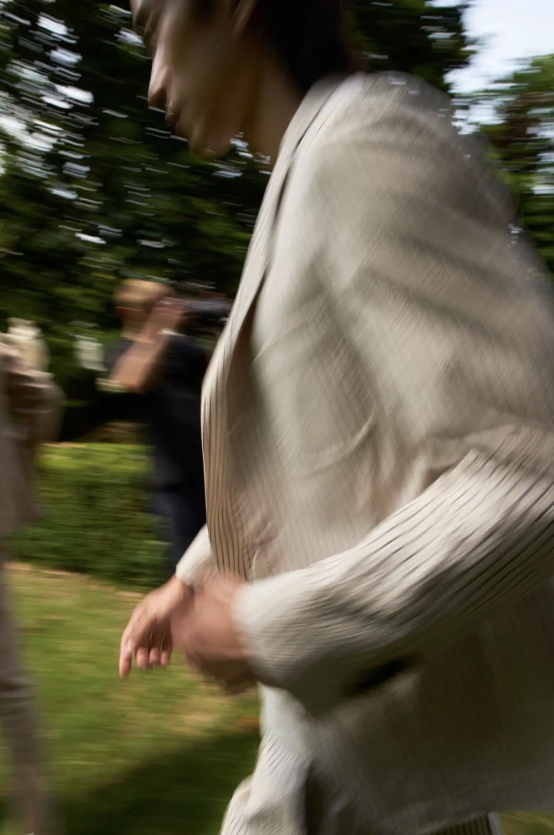 A person moving through a garden