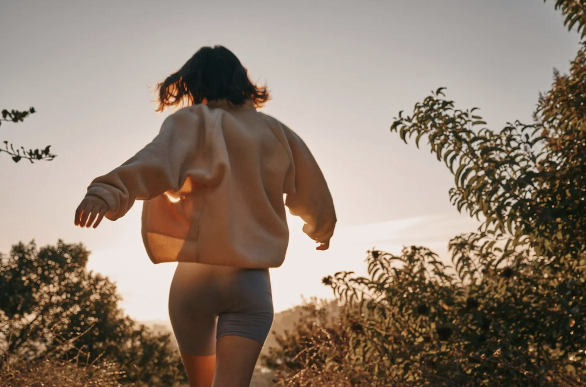 A person in motion against soft daylight